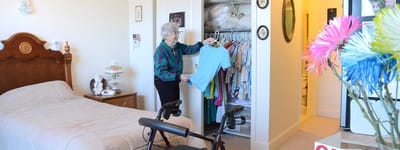 Resident organizing clothes in a cozy room