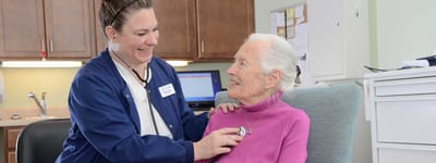 Nurse attending to a resident in a cozy room