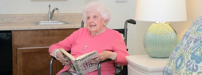 Resident reading in a cozy living area