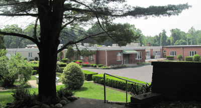 Exterior view of the facility surrounded by greenery