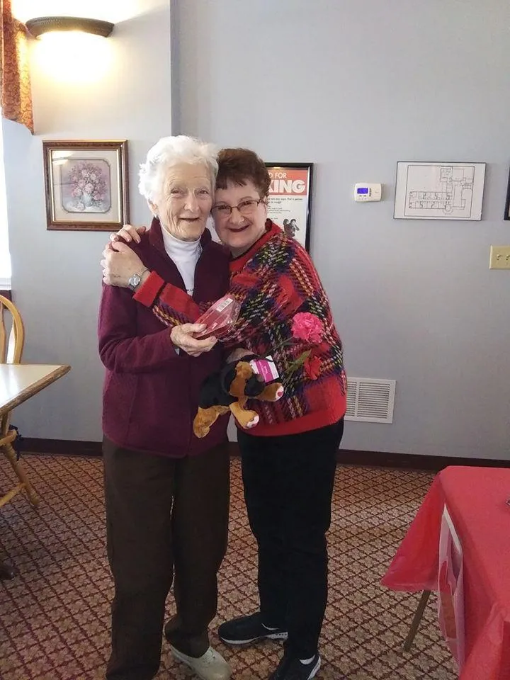 Residents celebrating with a staff member indoors