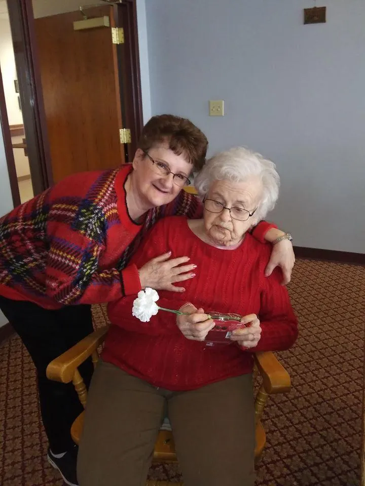 Staff and resident sharing a moment in a cozy interior