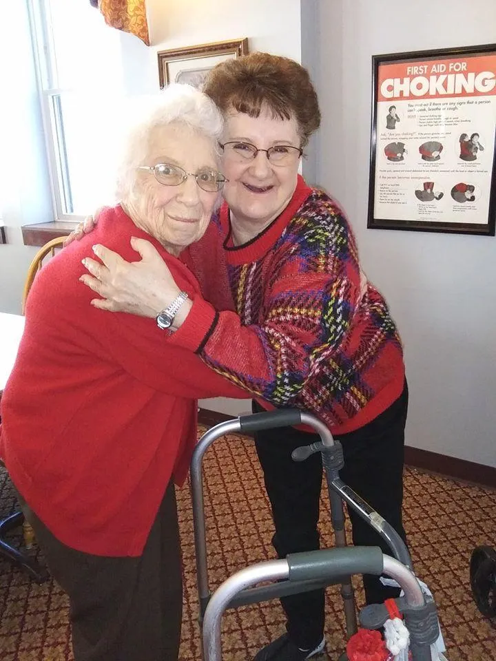 Two residents embracing in a common area