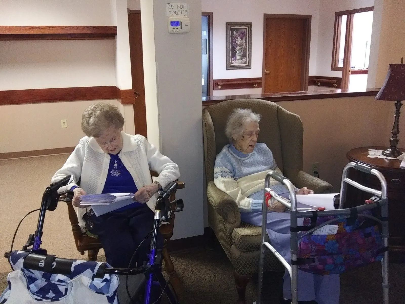 Two residents reading in a common area