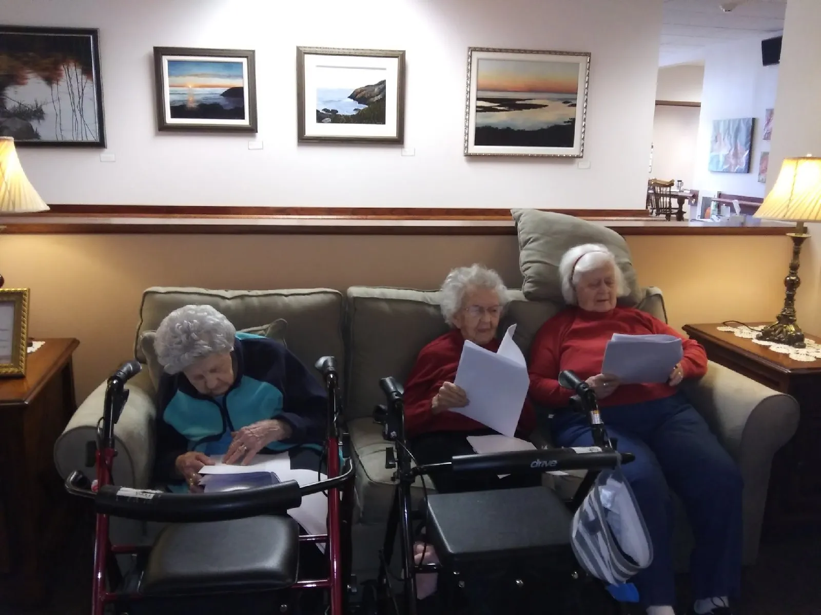 Three residents reading in a cozy common area