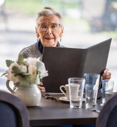 Senior woman reading a menu in a dining area