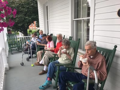 Residents enjoying ice cream on a porch