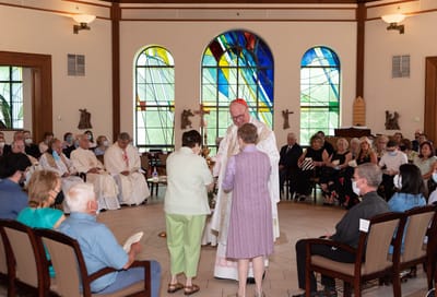 Residents participating in a ceremony in a common area
