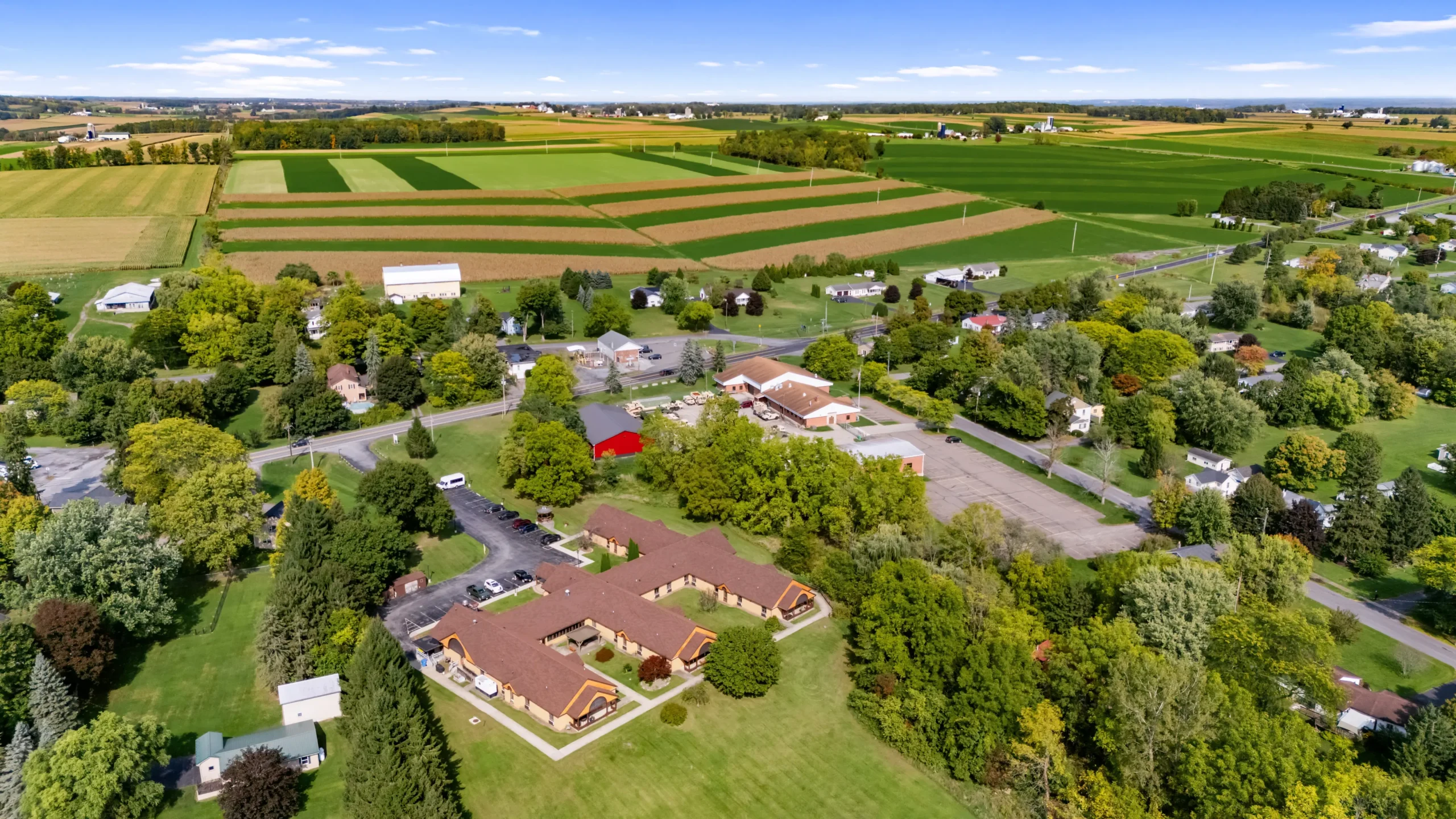 Aerial view of Clinton Crest Manor surrounded by fields