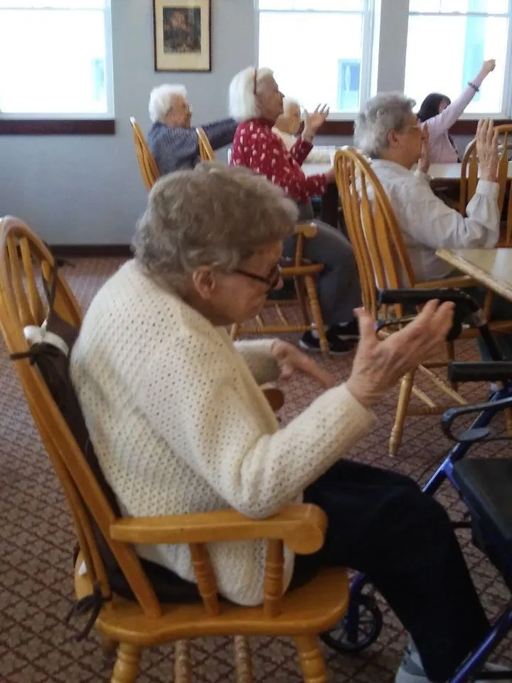 Residents participating in a seated activity in a common area