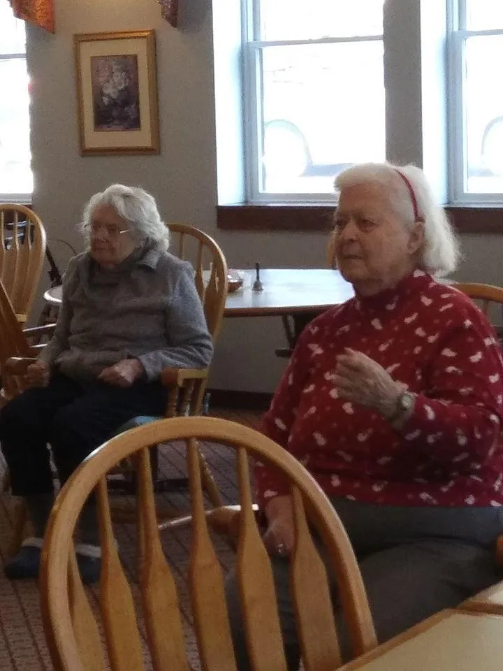 Two elderly residents seated in a common area