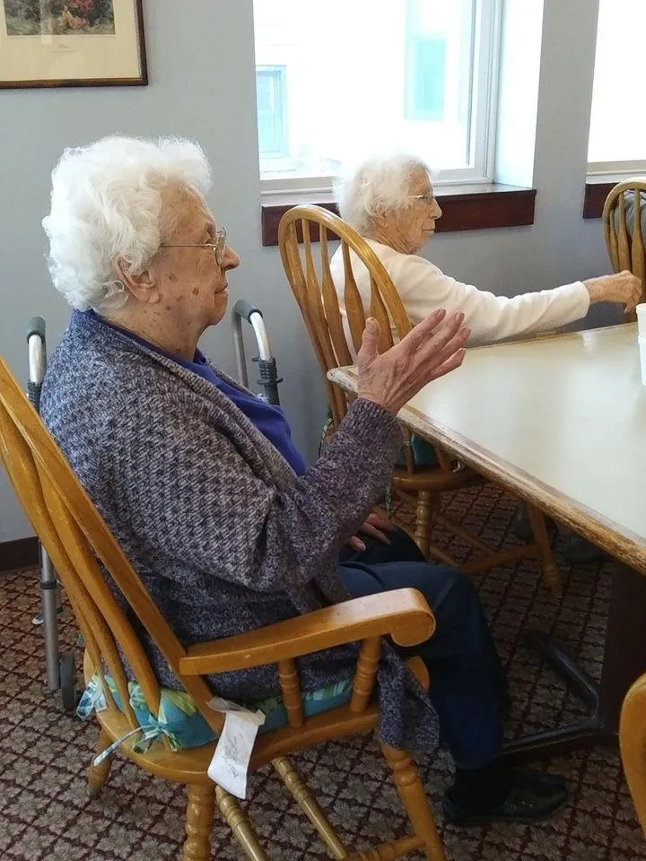 Residents engaged in conversation in a common area.