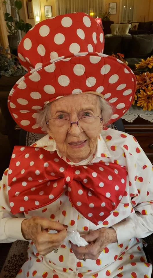 Resident dressed in playful costume with large bow and polka dots