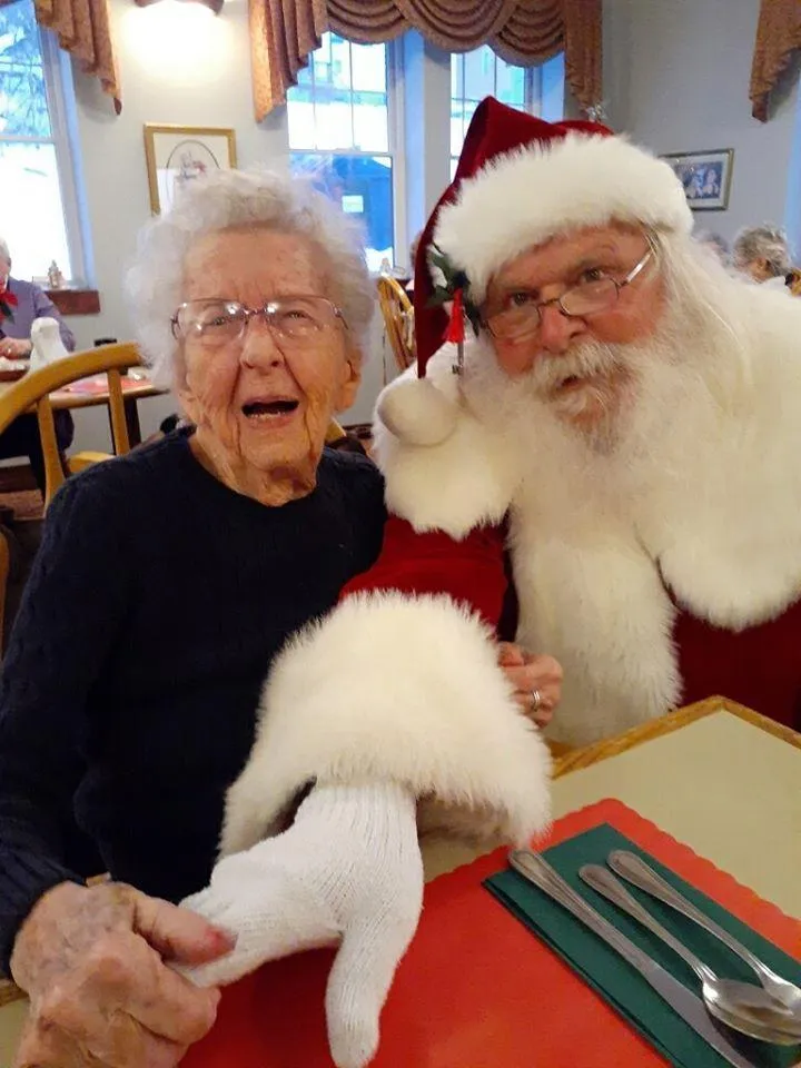 Resident with Santa during a holiday celebration