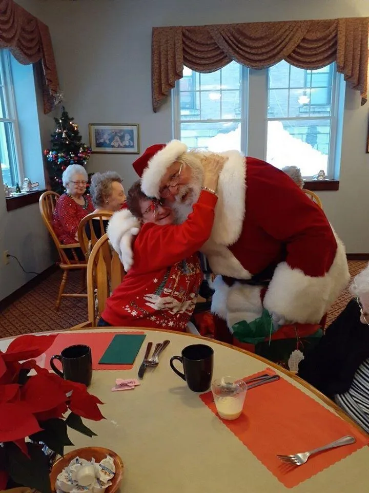 Residents celebrating Christmas with Santa Claus in a common area