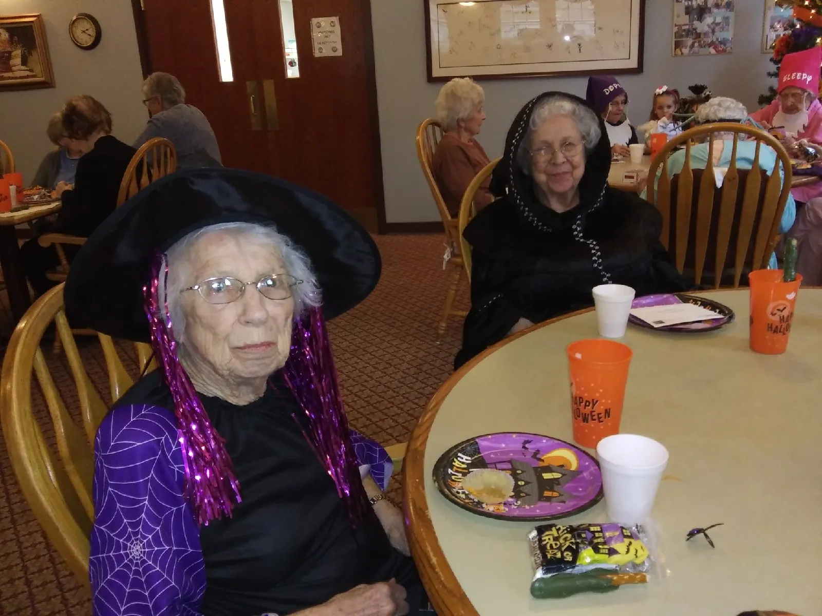 Residents enjoying a Halloween-themed gathering in the dining room