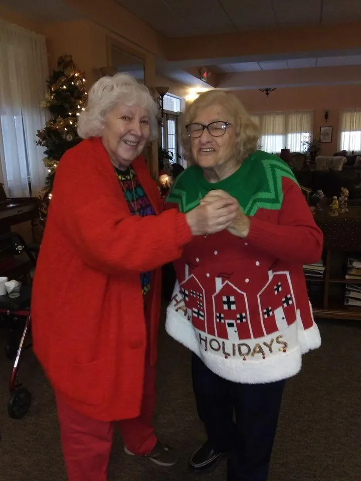 Two residents dancing and celebrating the holidays