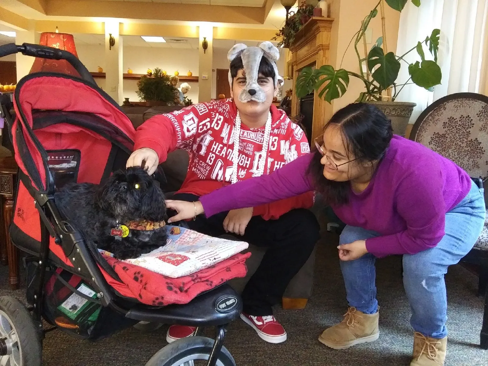 Residents interacting with a dog indoors