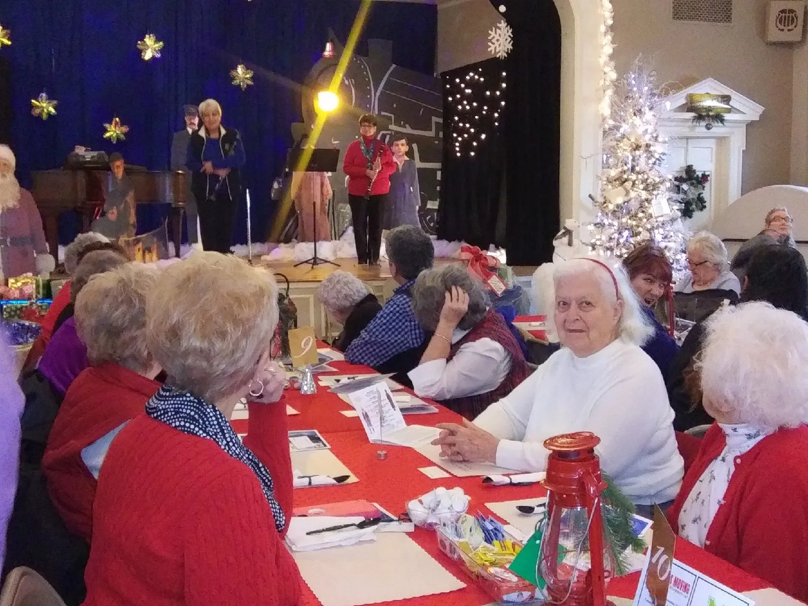Residents enjoying a holiday event in a festive interior