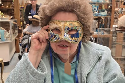 Resident wearing a masquerade mask at an activity event