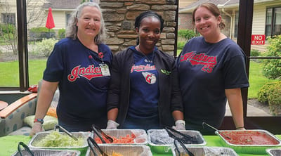 Staff serving food at an outdoor event