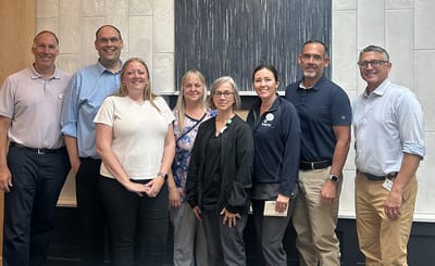 Staff members posing in a common area