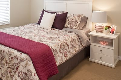 Cozy bedroom with floral bedding and nightstand