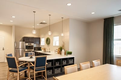 Bright interior kitchen area with dining table and seating