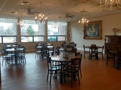Dining area with tables and chairs in a well-lit room
