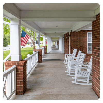 Porch with rocking chairs and American flags