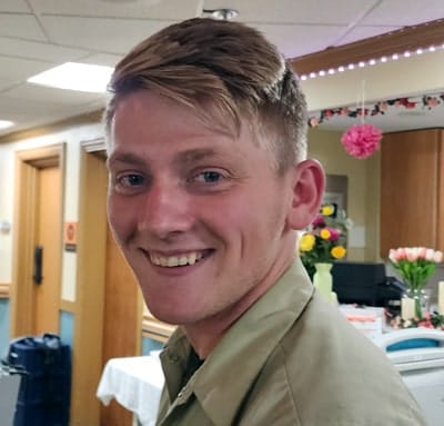 Staff member smiling in the facility's common area