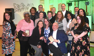 Group of staff celebrating awards at an event