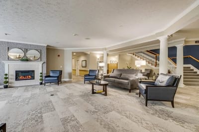 Bright common area with seating and fireplace