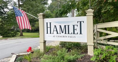 Sign for Hamlet at Chagrin Falls with American flag