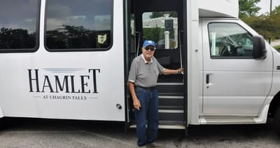 Senior resident boarding a facility transport van