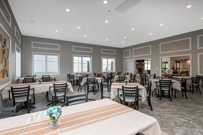 Dining area with tables and chairs in a well-lit room