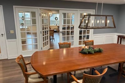 Dining area with a large wooden table and chairs