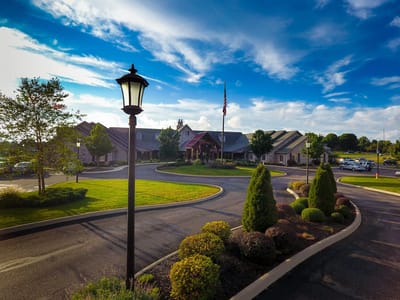 Entrance view of the Inn at University Village with landscaped exterior