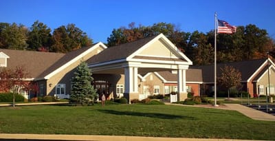 Exterior view of a senior living facility with landscaping
