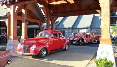 Classic cars at the entrance of a senior living facility