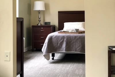 Cozy resident room with a bed and bedside table