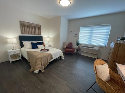 A furnished resident room in a senior living facility