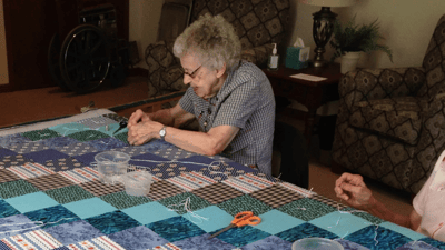 Residents engaged in a crafting activity indoors