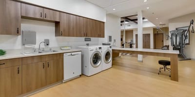 Interior view of a laundry room with appliances and workspace