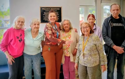 Residents and staff posing together in a common area