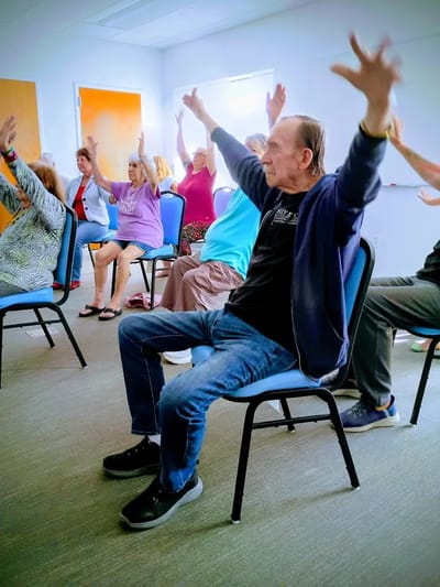 Residents participating in a seated exercise activity