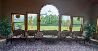 Interior view of a common area with chairs and windows