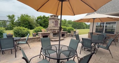 Outdoor patio area with seating and a fireplace