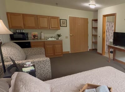 Cozy interior of a resident's room with a sofa and kitchenette