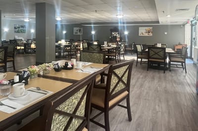Dining area with tables and chairs set for meals